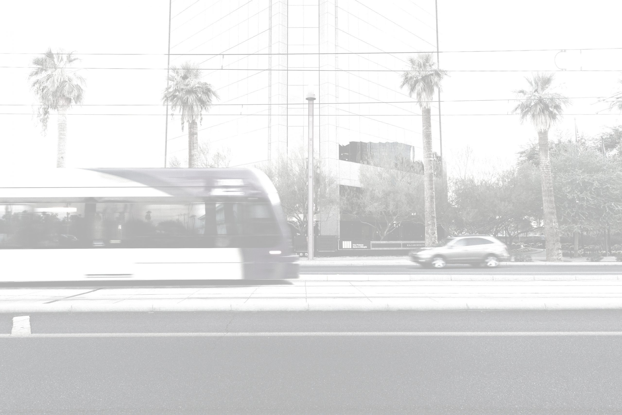 City train in motion (stop motion photography) with building and palm trees in background